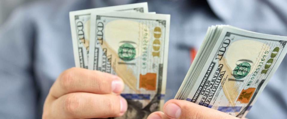 Businessman counting hundred dollar bills. Money and trade concept. Close up