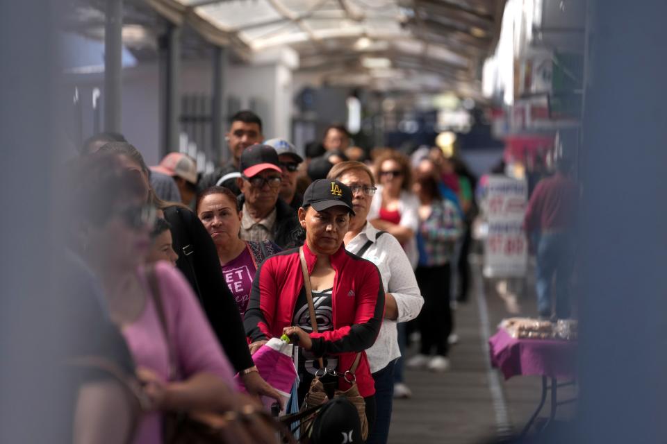 People wait in line at the U.S. Customs and Border Protection Dennis DeConcini Port of Entry in Nogales, Sonora, on May 12, 2023.