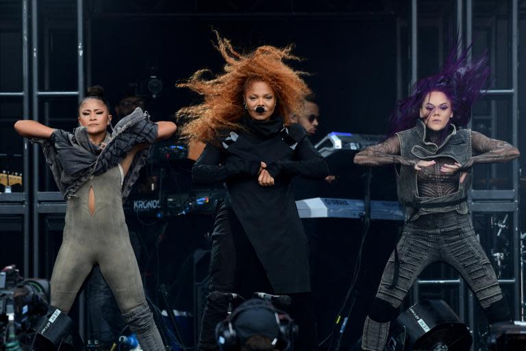 It’s not quite 6 o’clock when Janet Jackson appears on the Pyramid Stage – unusual, perhaps, for an artist of her renown. Jackson certainly seems to think so herself; perhaps unhappy with her position on the bill, she announced her appearance at Worthy Farm by doctoring the official poster. Media outlets gleefully reported Jackson’s team’s audacious decision to move her name to top left billing. Jackson is a cultural powerhouse: both a veteran live performer and a match-fit one – it’s clear that today’s meticulously rehearsed performance comes after a run of acclaimed shows in Las Vegas. Despite a slightly late start, the show kicks off with business-like professionalism, Jackson rising through the floor of a raised platform on the (otherwise simple) stage. There’s something sleekly superhuman about Jackson’s stage presence: from her flaw-free skin (Jackson is 53, and gave birth to her first child at 50) to her micro-choreographed movements. Dressed in a heavy black cowl neck with patent leather shoulder detailing and enormous matching boots, she gestures with laser-like precision: every finger wag, head tilt and narrowed eye is deliberate.Her back catalogue flirts with diverse musical styles. There’s the industrial beats on opener “Trust to Try”, the provocative funk of “What Have You Done For Me Lately” and the warm, bright pop of “All For You”. Janet glides through them all seamlessly, from the crisp, sharp and sexual choreography on “If” (including a moment where Jackson puts the head of a male dancer between her legs) to head-banging and bottom-lip-biting air guitar on “Black Cat”. Even her most recent release, 2018’s “Made For Now”, feels right at home, and proves as popular with the crowd as any of her classic hits. The setlist is front-loaded with some of her most famous songs thanks to a medley that includes “What Have You Done For Me Lately”, “Control”, “Nasty”, “The Best Things In Life Are Free” and “All For You”, but it’s a credit to Jackson’s career that she doesn’t run out of hits.It’s a well-choreographed show of her greatest hits. There are some issues, though. It’s a slightly thinner crowd than you might expect – probably due to an unfortunate clash with one of 2019’s biggest pop divas, Lizzo. At times, Jackson’s vocal is too quiet, struggling to be heard over the other tracks. She deals with technical problems with grace (and is perhaps the only woman alive who is able to make dabbing herself with a towel look more sensual than Rachel from Friends did), but it sometimes feels as though Jackson is so rehearsed that she’s merely going through the motions: a warm laugh at the opening notes of “Escapade” is a welcome flash of her human side.Over the past few years, Jackson’s live performances and her oeuvre have been reassessed with new admiration and a sense that, until now, her many contributions to the musical landscape have been overlooked. In March, she was conducted into the Rock and Roll Hall of Fame. There are no mentions to her brother Michael tonight (their collaboration “Scream” is absent from the setlist), other than a brief moment where she references “my brothers, the Jacksons”, incorporating moves from the Jackson 5’s career and the “Thriller” video into a dance break. At the best of times, it’s a challenge to walk in the footsteps of a more influential sibling, even more so when their cultural footprint is being seriously reconsidered. But Jackson has always been able to refuse to bear the burdens of her family’s history, despite its enormous weight.