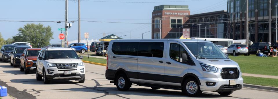 Vehicles pull into a private parking lot near Lambeau Field before the preseason game with the New England Patriots on Aug. 19 in Green Bay.