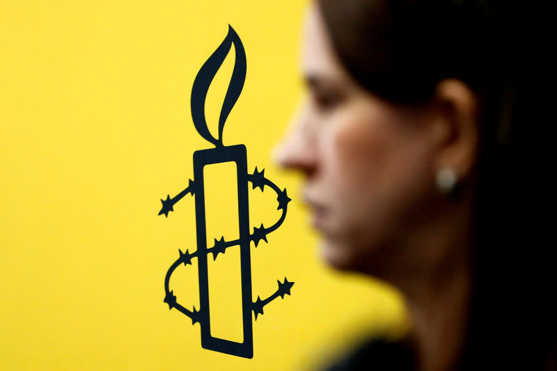 FILE PHOTO: The logo of Amnesty International is seen next to director of Mujeres En Linea Luisa Kislinger, during a news conference to announce the results of an investigation into humans rights abuses committed in Venezuela during protests against President Nicolas Maduro in Caracas, Venezuela February 20, 2019. REUTERS/Carlos Jass