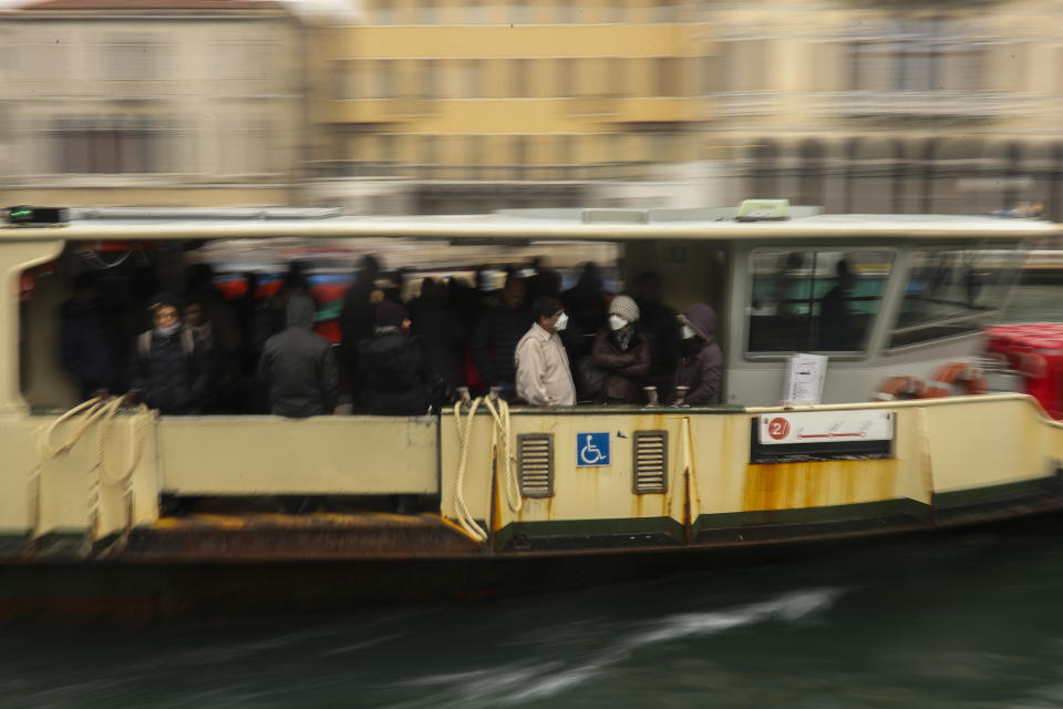 Commuters and locals take a bus boat in Venice, Italy, Monday, March 2, 2020. Venice in the time of coronavirus is a shell of itself, with empty piazzas, shuttered basilicas and gondoliers idling their days away. The cholera epidemic that raged quietly through Venice in Thomas Mann's fictional "Death in Venice" has been replaced by a real life fear of COVID-19. (AP Photo/Francisco Seco)