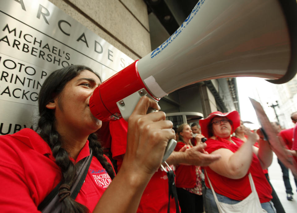 Chicago Teachers Union members picket prior to a Chicago Board of Education meeting on Wednesday, Aug. 22, 2012 in Chicago. The union called for fair contracts with higher pay for its teachers. (AP Photo/Sitthixay Ditthavong)