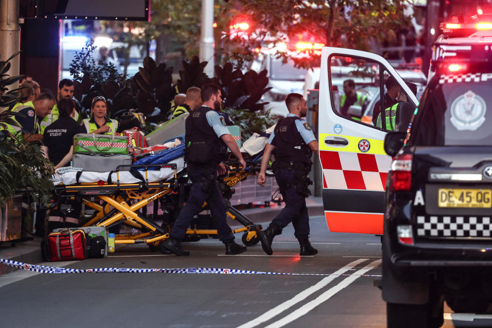 Police and paramedics work outside the Westfield Bondi Junction shopping mall after the stabbing incident on Saturday. Credit: AFP via Getty Images