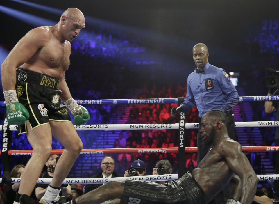 Tyson Fury, of England, knocks down Deontay Wilder during a WBC heavyweight championship boxing match Saturday, Feb. 22, 2020, in Las Vegas. (AP Photo/Isaac Brekken)