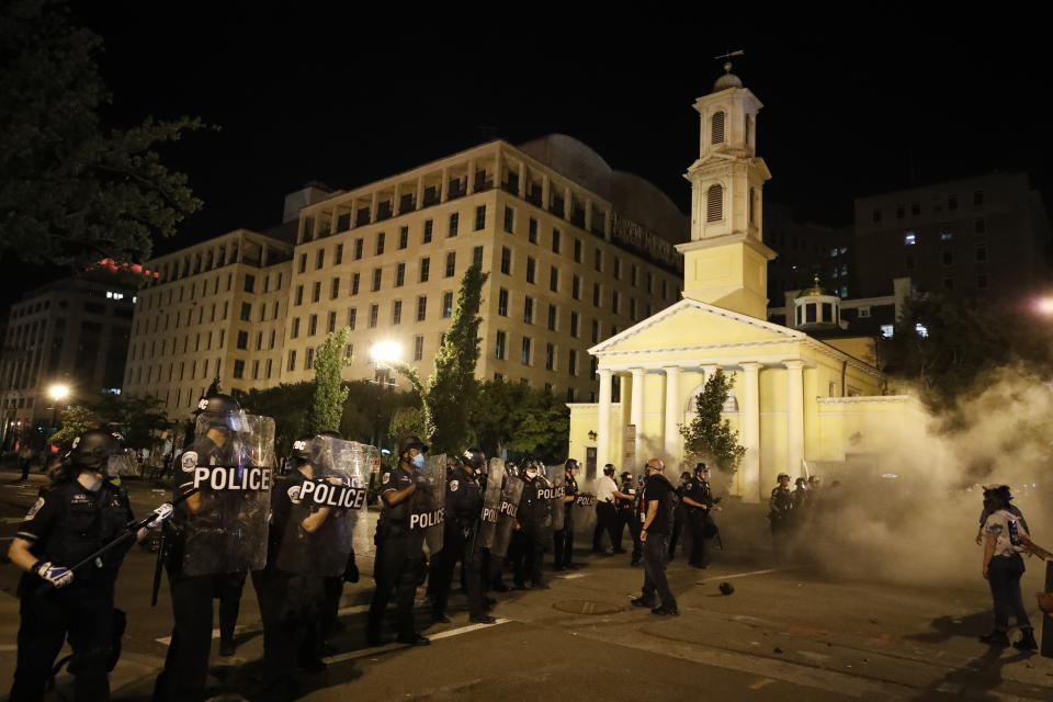 FILE - In this Saturday, May 30, 2020 file photo, police for a line near St. John's Episcopal Church as demonstrators gather to protest the death of George Floyd, near the White House in Washington. Floyd, a Black man, died after being restrained by Minneapolis police officers. St. John's, at the epicenter of protests in Washington, has a long legacy on civil rights dating to its embrace of the 1963 March on Washington. (AP Photo/Alex Brandon)