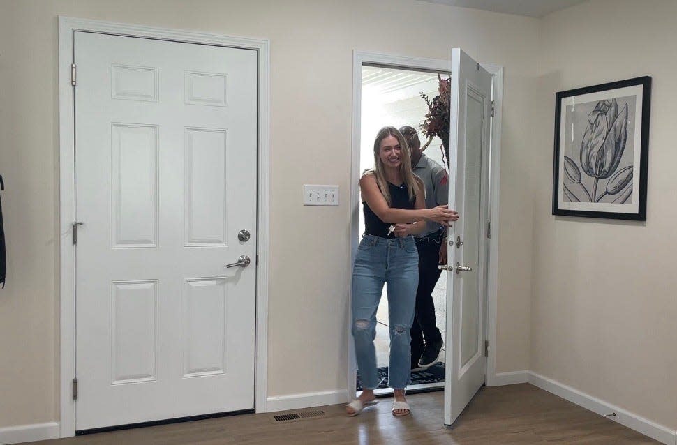 Nikole Cunningham enters through her front door to find her new home fully furnished with the help of former NFL running back Warrick Dunn.