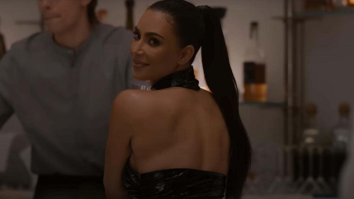  Kim Kardashian looks over her shoulder with an evil smile in AHS Delicate: Part Two. 