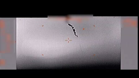 A plume of smoke which U.S. Department of Defence claims to be left by the U.S. drone after its downing, allegedly over the Gulf of Oman, is seen in this still image taken from video released by the U.S. Department of Defense