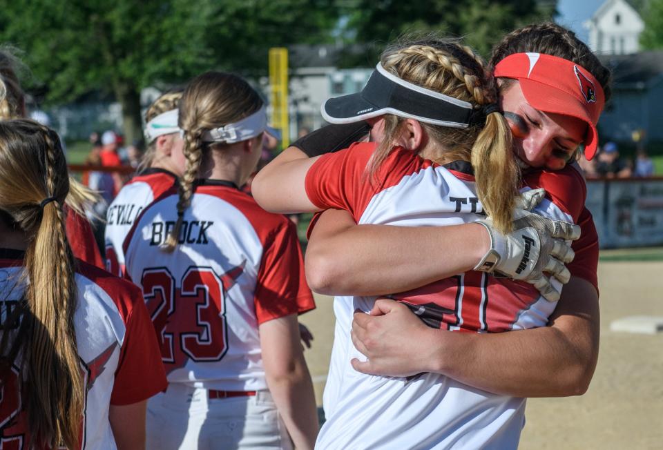 Metamora's Katy Ramage, right, and teammate Kaidance Till embrace after the Redbirds' 9-3 victory over East Peoria in the Class 3A state softball sectional title game Friday, June 3, 2022 in Washington.