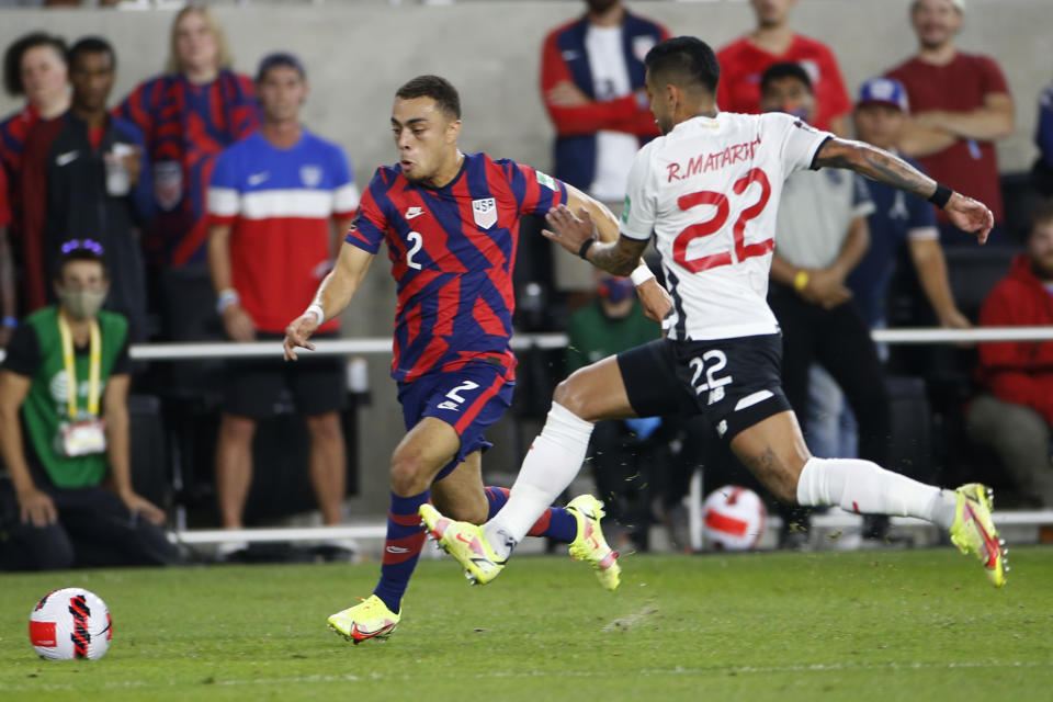 United States' Sergino Dest, left, dribbles the ball upfield as Costa Rica's Ronald Matarrita defends during the first half of a World Cup qualifying soccer match Wednesday, Oct. 13, 2021, in Columbus, Ohio. (AP Photo/Jay LaPrete)