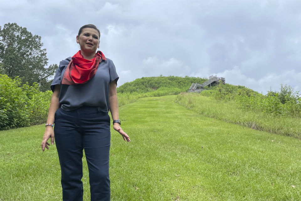 Tracie Revis, a citizen of the Muscogee Creek Nationposes at the Great Temple Mound in Ocmulgee Mounds National Historical Park in Macon, Ga., on Aug. 22, 2022. (AP Photo/Michael Warren)
