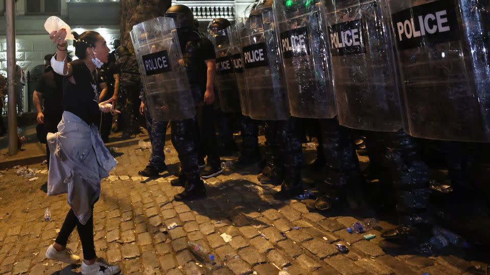 A woman stares down a wall of riot police in Tbilisi, April 30, 2024. - Giorgi Arjevanidze/AFP/Getty Images