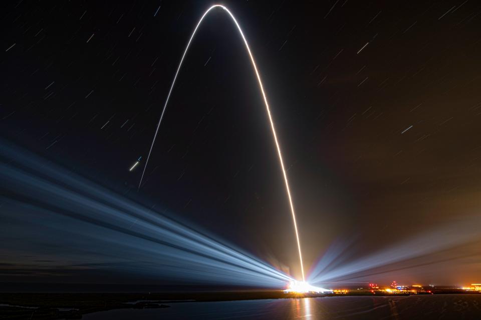 a streak of light arcs across the sky