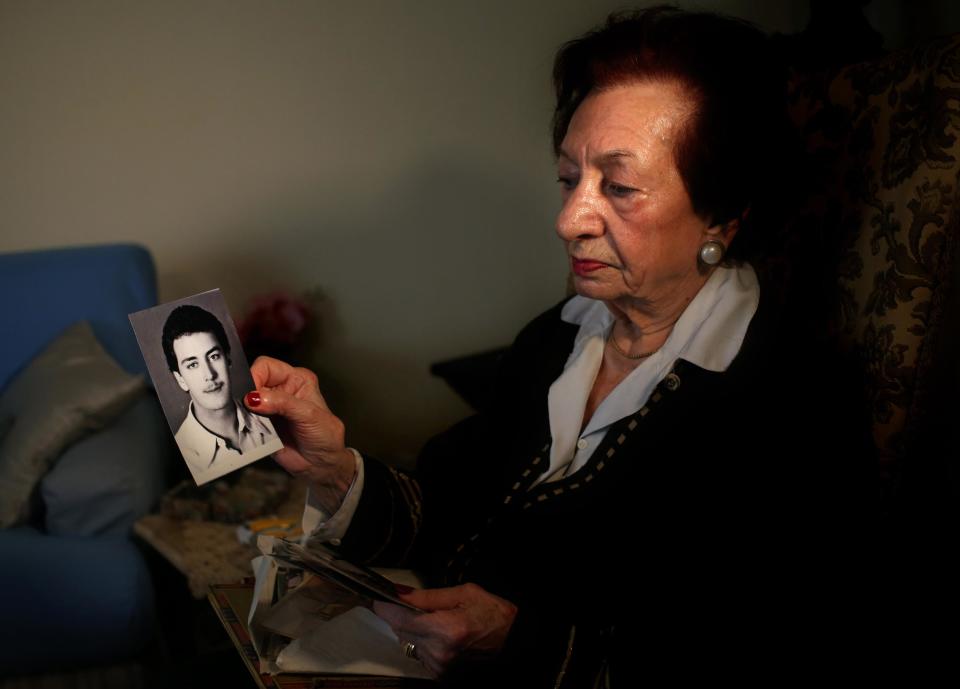 In this Thursday April 10, 2014 photo, Lebanese Mary Mansourati, 82, whose son Dani went missing in Syria in 1992 at the age of 30, show his portrait during an interview with the Associated Press at her house, in Beirut, Lebanon. Dani is among an estimated 17,000 Lebanese still missing from the time of Lebanon’s civil war or the years of Syrian domination that followed. Syria’s civil war has added new urgency to the plight of their families, many of whom are convinced their loved ones are still alive and held in Syrian prisons, at risk of being lost or killed in the country’s mayhem. (AP Photo/Hussein Malla)