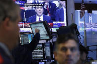 <p>Stock traders at the New York Stock Exchange watch former FBI Director James Comey on a television monitor, Thursday, June 8, 2017, as he testifies before a congressional committee in Washington. (Photo: Mark Lennihan/AP) </p>