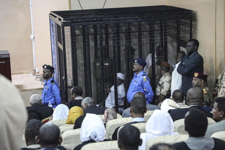 Sudan's autocratic former President Omar al-Bashir sits in a cage during his trial on corruption and money laundering charges in Khartoum, Sudan, Saturday, Aug. 24, 2019. (AP Photo)