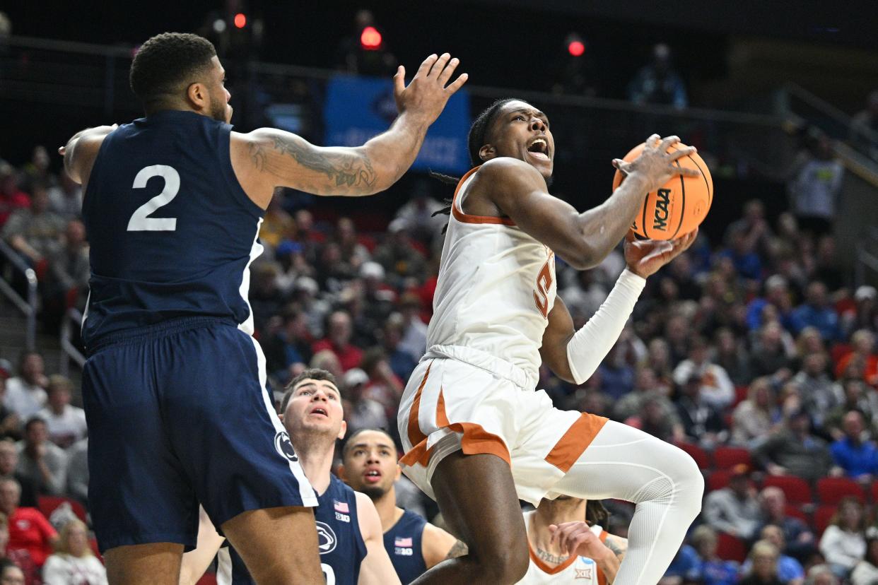 Texas guard Marcus Carr, right, drives against Penn State's Myles Dread during the Longhorns' 71-66 win in a NCAA second-round game Saturday in Des Moines, Iowa. The victory propelled Texas into a Sweet 16 meeting with Xavier Friday in Kansas City, Mo.