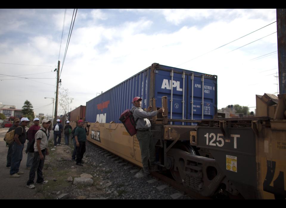 In this May 17, 2012 photo, migrants, mostly from Honduras, wait for a train going north in Lecheria, on the outskirts of Mexico City. While the number of Mexicans heading to the U.S. has dropped dramatically, a surge of Central American migrants is making the 1,000-mile northbound journey this year, fueled in large part by the rising violence brought by the spread of Mexican drug cartels. (AP Photo/Alexandre Meneghini)  