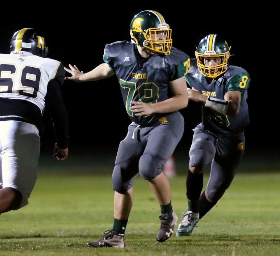 St. Mark's Connor Kilby protects quarterback Chase Patalano in the second quarter of the Spartans' 34-6 win at St. Mark's High School, Friday, Sept. 24, 2021.