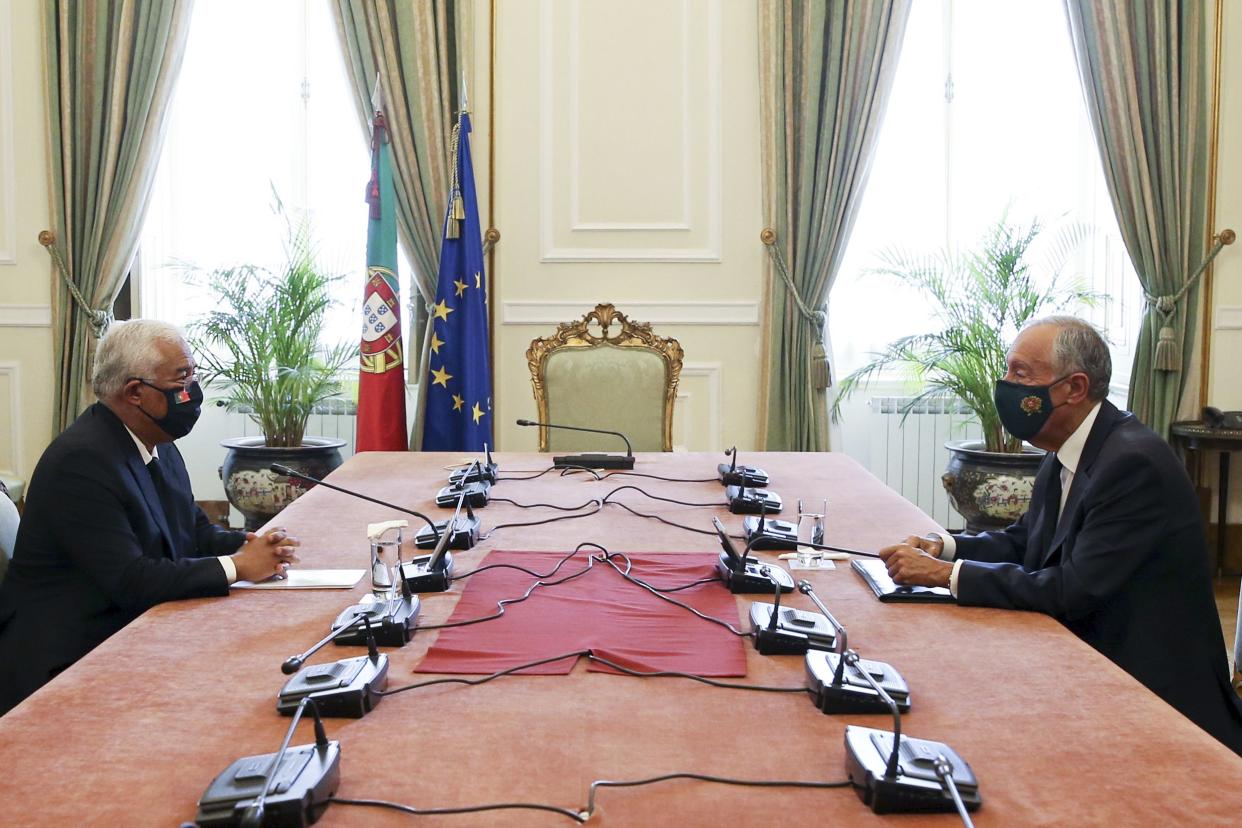 Portuguese Prime Minister Antonio Costa, left, meets with Portuguese President Marcelo Rebelo de Sousa at the Belem presidential palace in Lisbon, Portugal on Monday, Nov. 2, 2020. The country is introducing new restrictions on Wednesday that will affect some 7 million people, around 70% of the population, and tighter limits, such as curfews or lockdowns, constitutionally require a state of emergency to be declared first. The president, who is the only one who can decree a state of emergency, is to discuss the possibility with the prime minister.