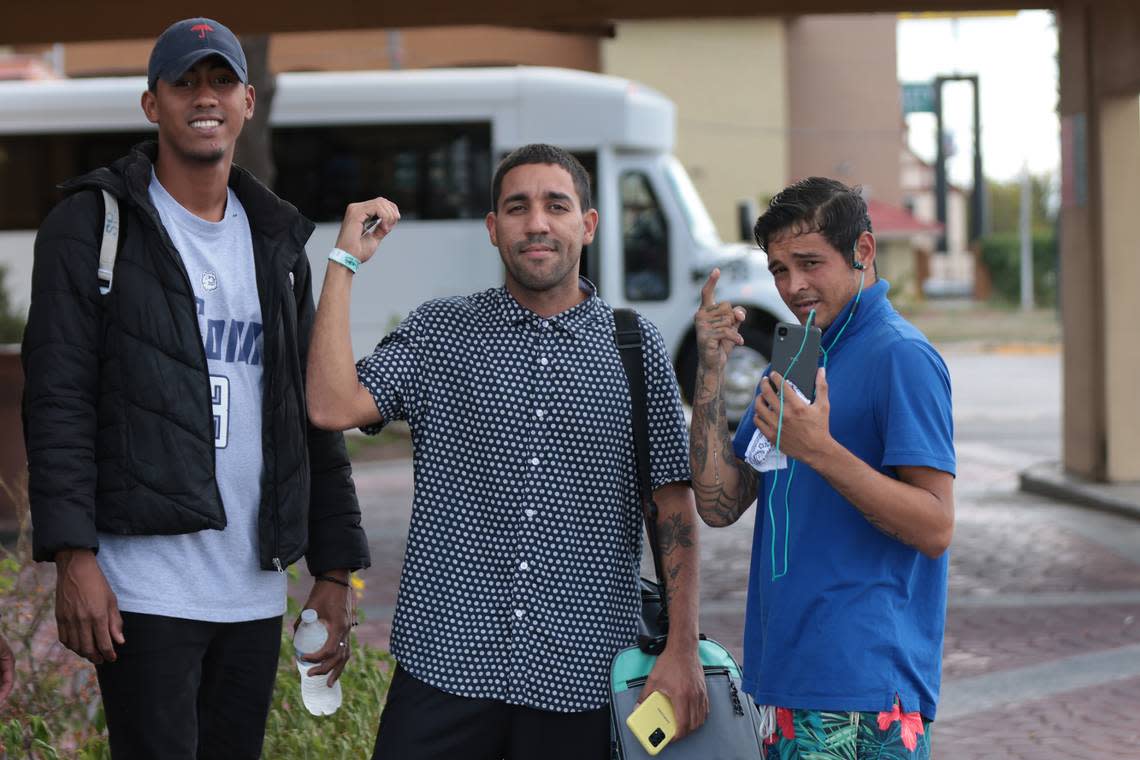 Pedro Escalona, far right, was recruited for Gov. DeSantis’ migrant relocation program in San Antonio, but the planned flight to Delaware was canceled. He talked on the phone as he boarded a bus back to the Texas shelter.