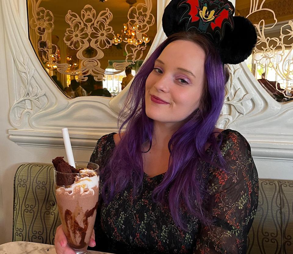 jenna posing with a chocolate caramel pecan milkshake at the plaza restaurant in disney world