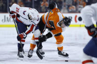 Philadelphia Flyers' Michael Raffl (12) and Washington Capitals' Lars Eller (20) compete for the puck during the second period of an NHL hockey game Wednesday, Jan. 8, 2020, in Philadelphia. (AP Photo/Matt Slocum)