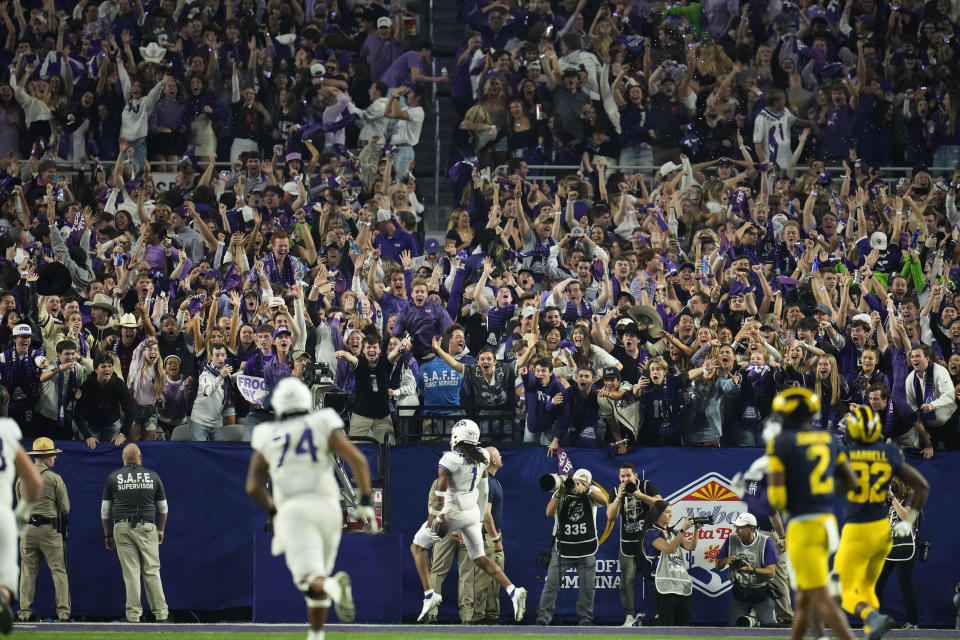 Fans cheer as TCU wide receiver Quentin Johnston (1) runs in for a touchdown during the second half of the Fiesta Bowl NCAA college football semifinal playoff game against Michigan, Saturday, Dec. 31, 2022, in Glendale, Ariz. (AP Photo/Ross D. Franklin)