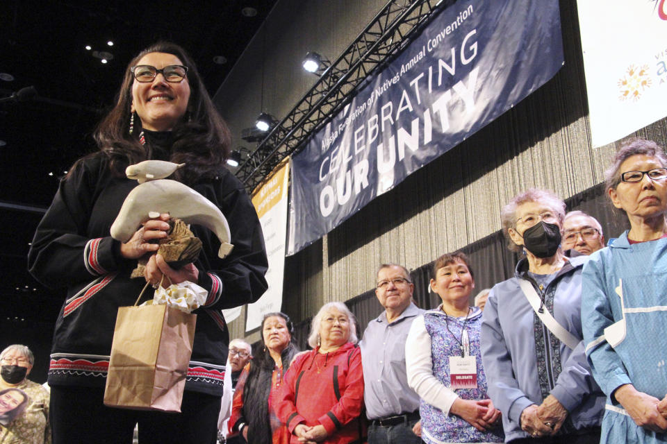 FILE - Rep. Mary Peltola, left, D-Alaska, acknowledges audience members singing a song of prayer for her at the Alaska Federation of Natives conference in Anchorage, Alaska, Oct. 20, 2022. After tidal surges and high winds from the remnants of a rare typhoon caused extensive damage to homes along Alaska’s western coast in September, the U.S. government stepped in to help residents — largely Alaska Natives — repair property damage. Residents who opened paperwork expecting to find instructions on how to file for aid in Alaska Native languages like Yup’ik or Inupiaq instead were reading bizarre phrases. Peltola, who is Yup’ik, said it was disappointing FEMA missed the mark with these translations. (AP Photo/Mark Thiessen,File)