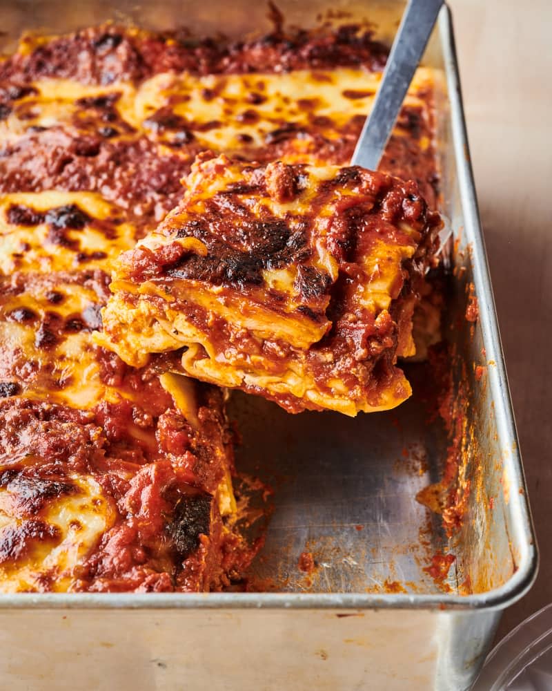 Slice of Allrecipes' World's Best Lasagna being lifted out of pan with spatula.