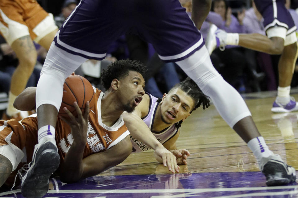 Texas forward Royce Hamm Jr., left, and Kansas State guard Mike McGuirl, right, go to the floor after a loose ball during the first half of an NCAA college basketball game in Manhattan, Kan., Saturday, Feb. 22, 2020. (AP Photo/Orlin Wagner)