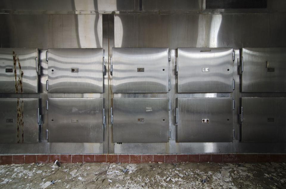 <p>A wall of mortuary drawers all sit empty in this barren morgue.</p>