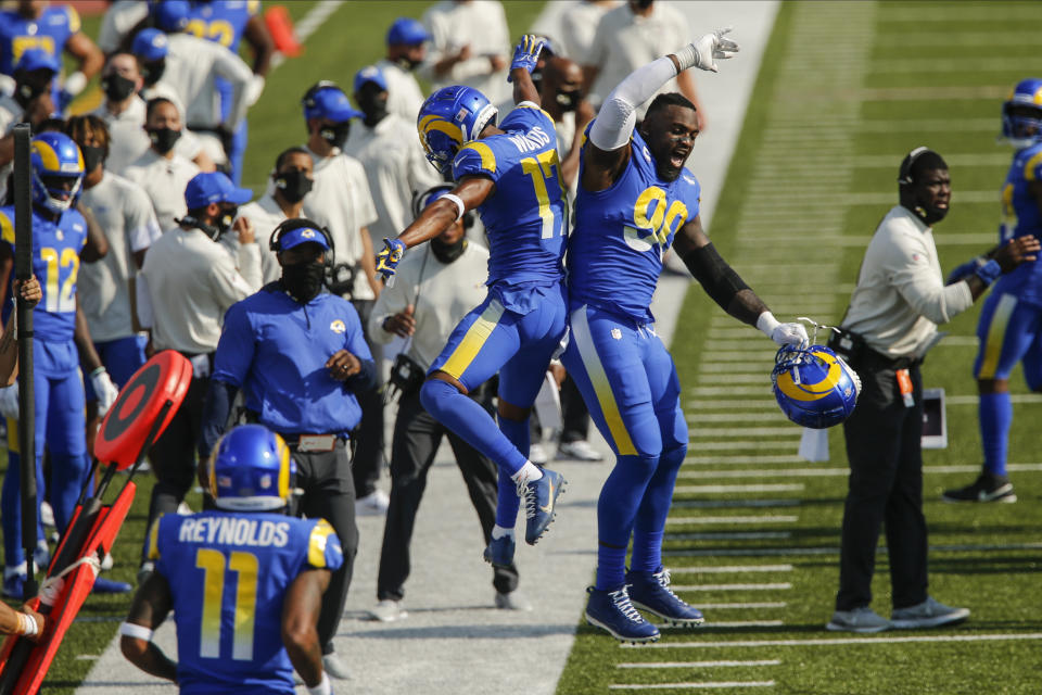 Los Angeles Rams' Robert Woods (17) and Michael Brockers (90) celebrate after Woods scored a touchdown during the second half of an NFL football game against the Buffalo Bills Sunday, Aug. 26, 2018, in Orchard Park, N.Y. (AP Photo/John Munson)