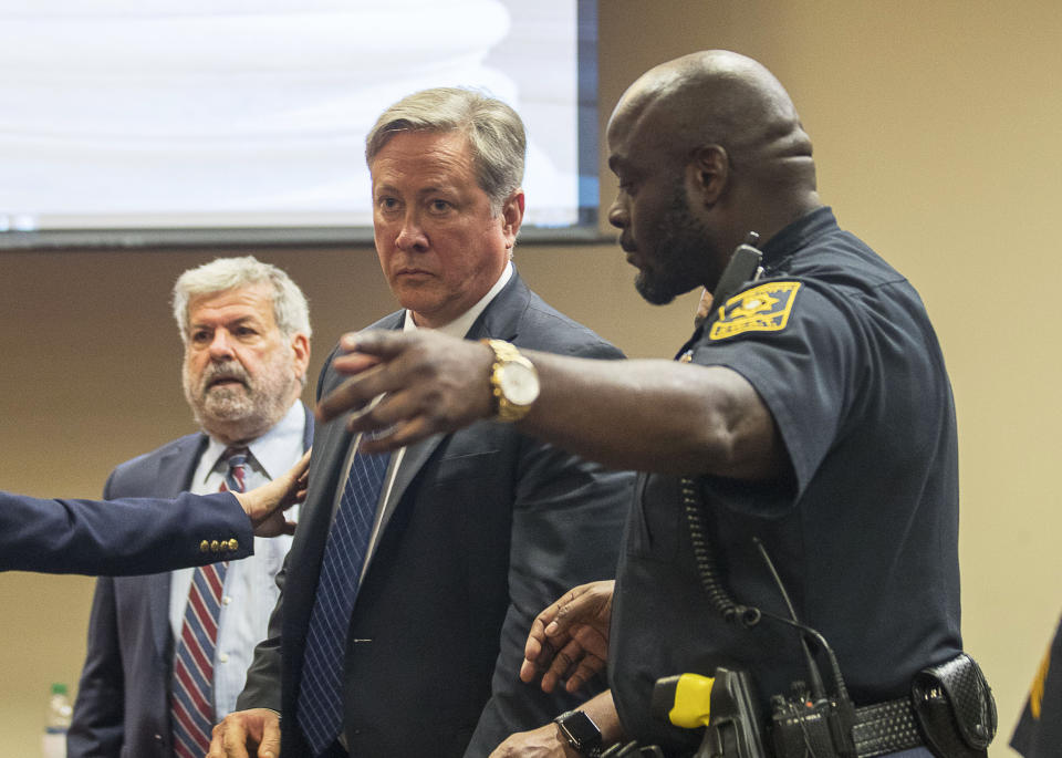 Robert "Chip" Olsen is escorted out of the courtroom after being found not guilty of felony murder for his trial in front of DeKalb County Superior Court Judge LaTisha Dear Jackson at the DeKalb County Courthouse in Decatur, Ga., Monday, Oct. 14, 2019. Olsen, a former Georgia police officer who fatally shot an unarmed, naked man, was found not guilty of murder on Monday, but was convicted of aggravated assault and other charges that could potentially send him to prison for more than 30 years. (Alyssa Pointer/Atlanta Journal-Constitution via AP, Pool)