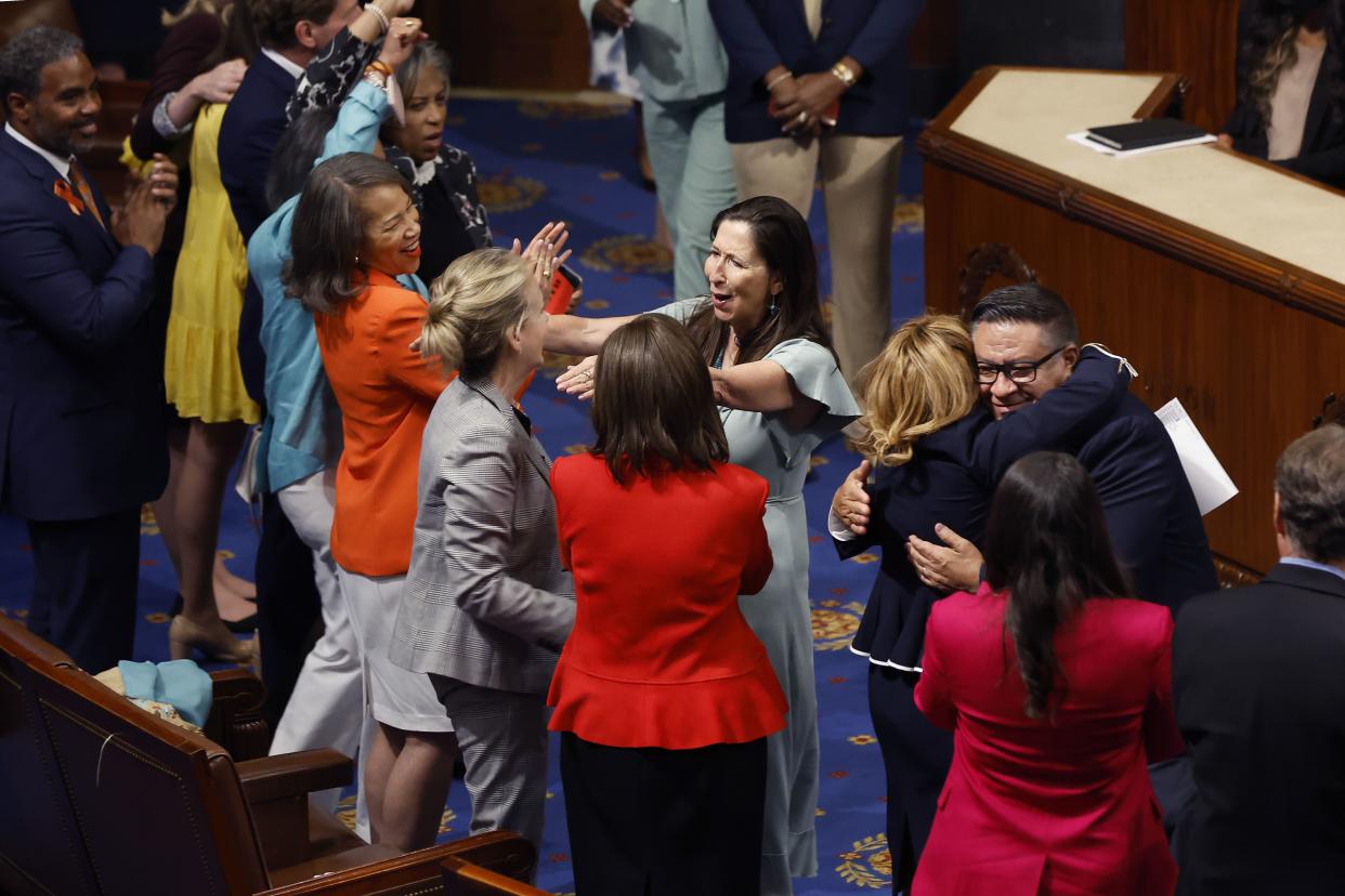 Democratic members of the House of Representatives cheer and embraces after the Bipartisan Safer Communities Act passed in the House Chamber on June 24, 2022 in Washington, DC. 