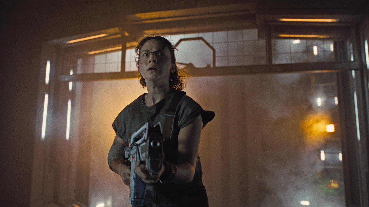  Cailee Spaney's character holds a gun and looks around her in a spaceship in Alien: Romulus. 