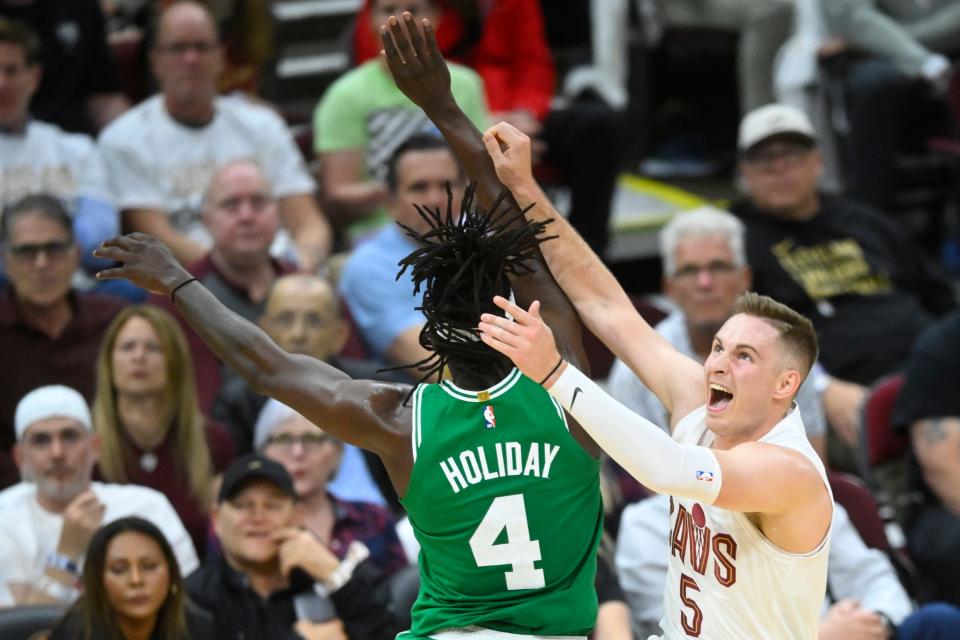 Celtics guard Jrue Holiday defends a shot by Cavaliers guard Sam Merrill in the third quarter of Game 4 of the Eastern Conference semifinals, May 13, 2024, in Cleveland.