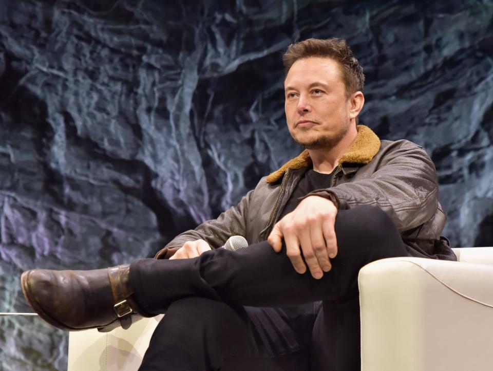 Tesla CEO Elon Musk sitting on stage at SXSW