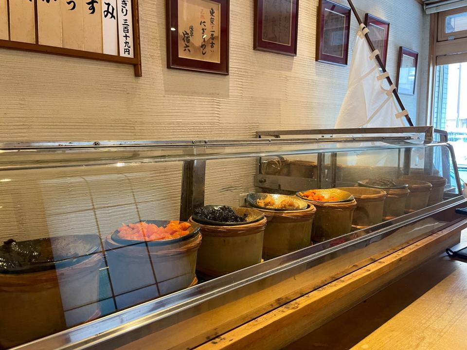 A glass case showcases the onigiri fillings.