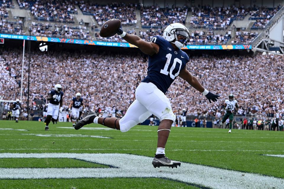 Penn State running back Nicholas Singleton (10) celebrates as he scores on a 70-yard touchdown run in the first half in State College, Pa.