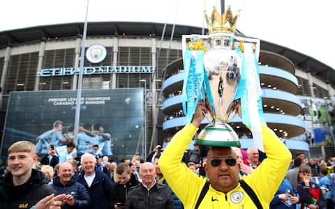 City fans with the trophy - Credit: getty images