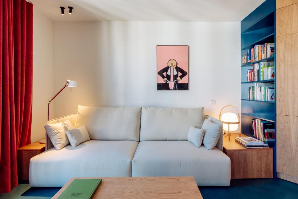 A white Joquer sofa allows surrounding colors (and a cheeky print by French illustrator Jean Jullien) to pop.