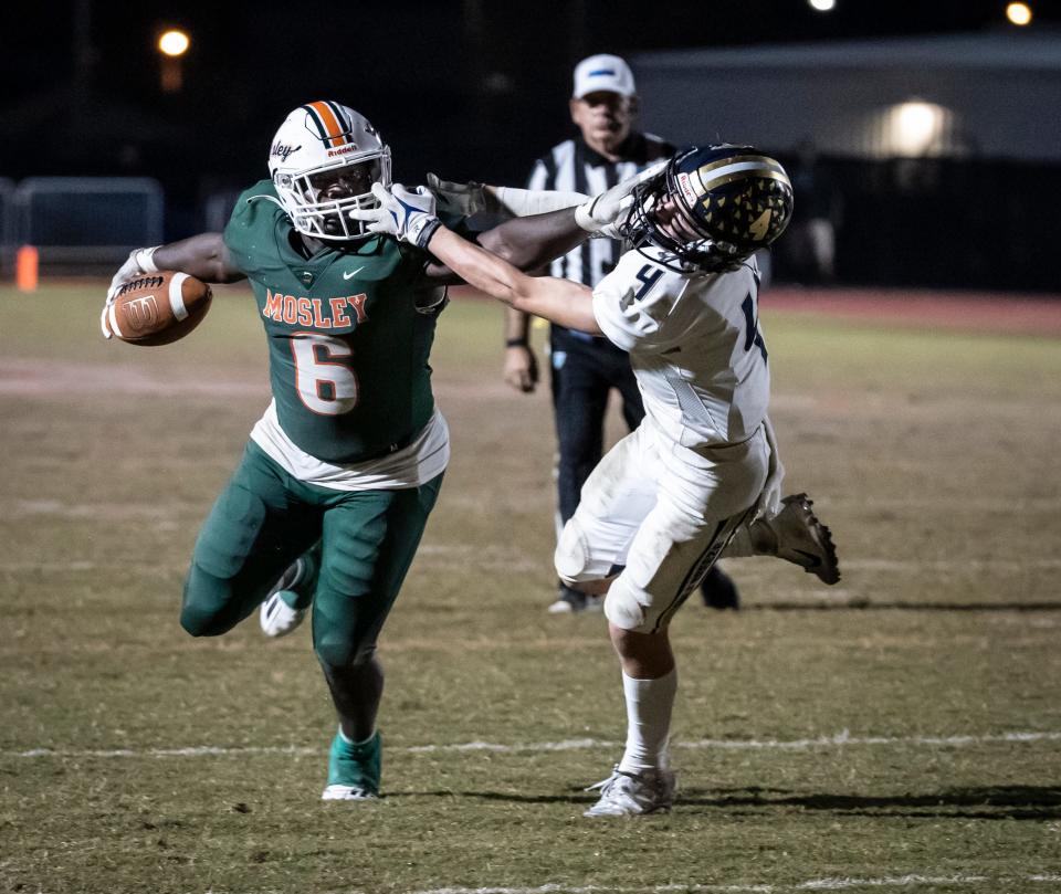 Mosley junior Randy Pittman sweeps around the end for extra yards to set up a touchdown. Mosley hosted Gulf Breeze in Regional quarterfinal action at Tommy Oliver Stadium Friday, November 12, 2021.