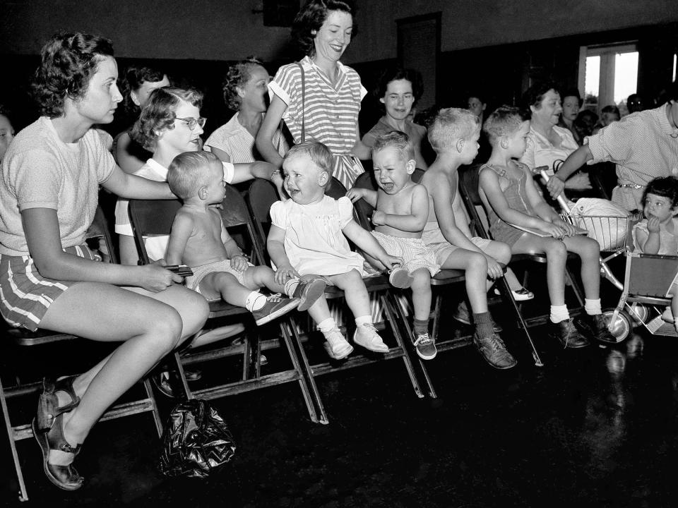 Mothers in Houtson, TX wait with their children to be inoculated with gamma globulin to prevent paralysis from polio.