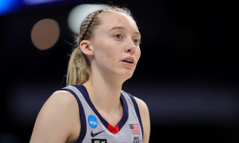 UConn star Paige Bueckers looks on.