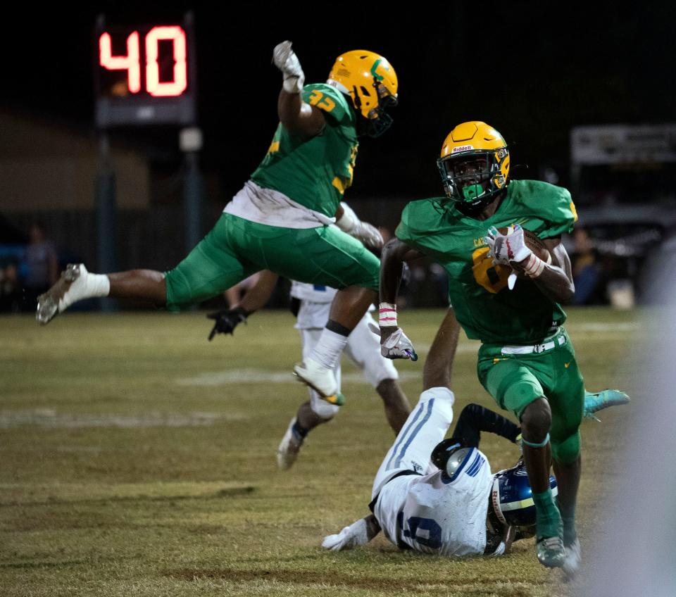 Catholic's Ja'bril Rawls (No. 6) blows past the Washington defense for a big gain during the first half of Friday Night's game against the Wildcats. 