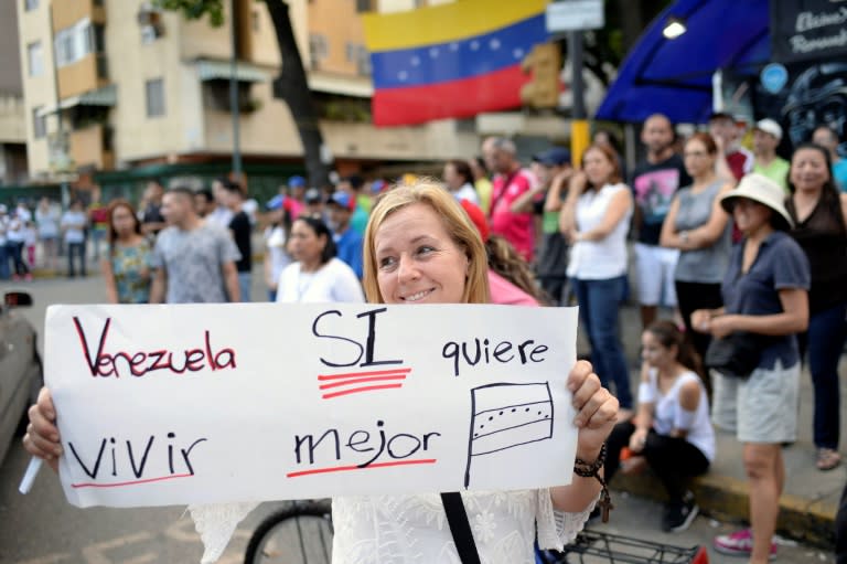 "Venezuela wants to live better" -- voters celebrate in Caracas after taking part in an opposition-organized ballot challenging embattled Venezuelan President Nicolas Maduro's plan to rewrite the constitution