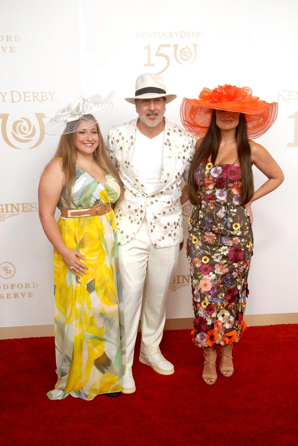 Joey Fatone, center, poses with his daughter, Briahna, left, and his date, Izabel Araujo, right, on the 150th Kentucky Derby red carpet Saturday. May 04, 2024