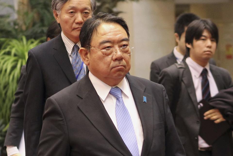 Japan's ambassador to China Masato Kitera walks to a meeting with China's Foreign Minister Wang Yi, at the Ministry of Foreign Affairs in Beijing